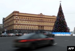 Cars drive past the headquarters of the FSB security service, the successor to the KGB in central Moscow on December 30, 2016.