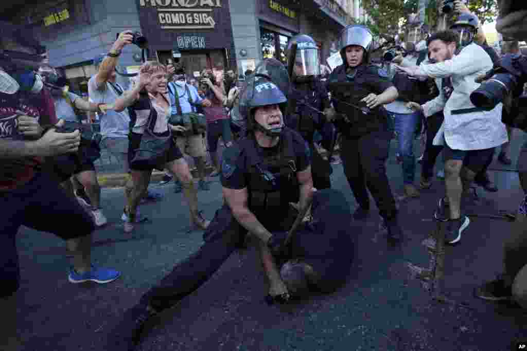 Riot police detain a demonstrator during a protest for better pensions for retirees in Buenos Aires, Argentina, March 5, 2025. 