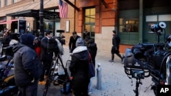 Members of the media report from outside the offices of the Tribeca Film Center, in New York, Thursday, Oct. 25, 2018. A New York City police bomb squad recovered a suspicious package addressed to Robert DeNiro. (AP Photo/Richard Drew)