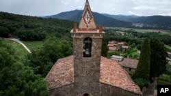 View of the bell tower of the 12th-century Sant Romà church, where students of the Vall d'en Bas School of Bell Ringers perform playing bells, in the small Spanish village of Joanetes, Spain, June 29, 2024. (AP Photo/Emilio Morenatti)