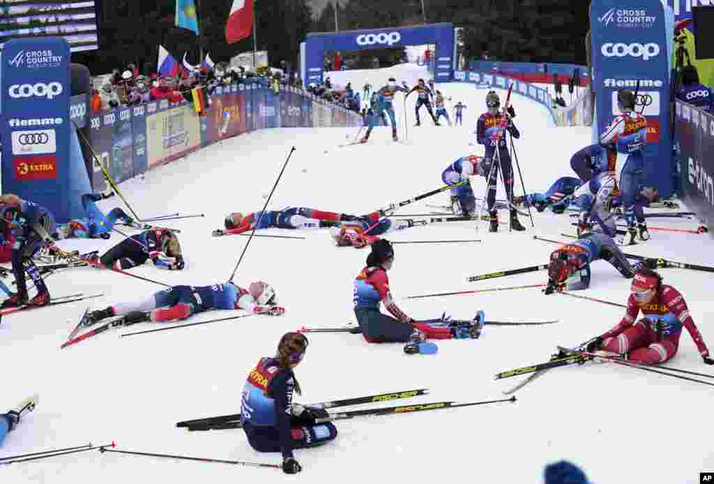 Participants recover at the finish line during the Women's Mass Start Free 10km event at the Tour de Ski in Val di Fiemme, Trento, Italy.