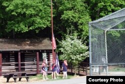 FILE - Girl scouts raise the American flag, the Stars and Stripes, at a camp in Catoctin Park, Maryland. (photo by Diaa Bekheet)