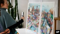 FILE - Journalists take pictures of the Paris 2024 Olympic and Paralympic posters in Ivry-sur-Seine, France, on Feb. 20, 2024. France announced on March 5 that potential security threats mean that tourists will not be able to attend the opening ceremonies.