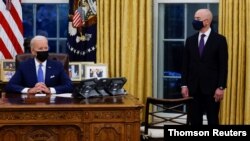 President Biden signs executive orders on immigration reform inside the Oval Office at the White House in Washington