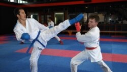This picture taken on May 11, 2021 shows Afghan-born refugee and karate competitor Asif Sultani (L) training on the outskirts of Sydney as he competes for a place on the Refugee Olympic Team at the…