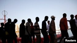 Migrants intercepted aboard a dinghy off the coast in the Mediterranean Sea, leave a rescue boat upon arrival at the port of Malaga, southern Spain, July 7, 2018.