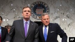 FILE - Senate Intelligence Committee Vice Chairman Mark Warner, D-Va., left, and Sen. Richard Burr, R-N.C., the panel chairman, are pictured prior to a hearing on Capitol Hill in Washington, May 9, 2018.