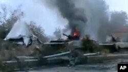 FILE - A Syrian military tank is shown as having caught fire outside Deir Ezzor, Jan. 29, 201.