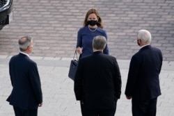 Supreme Court nominee Judge Amy Coney Barrett, center, walks toward White House Counsel Pat Cipollone, left, White House Chief of Staff Mark Meadows, center, and Vice President Mike Pence, right as they arrive on Capitol Hill, Sept. 29, 2020.