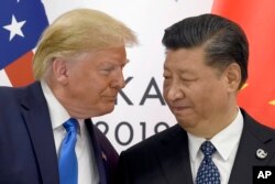 FILE - U.S. President Donald Trump meets with Chinese President Xi Jinping on the sidelines of the G20 summit in Osaka, Japan, on June 29, 2019.