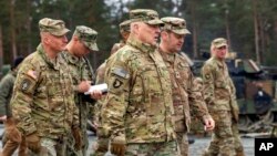 In this image provided by the U.S. Army, U.S. Chairman of the Joint Chiefs of Staff Gen. Mark Milley meets with U.S. Army leaders at Grafenwoehr Training Area, Grafenwoehr, Germany, Jan. 16, 2023. 