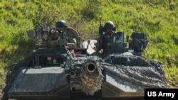 FILE - US soldiers in an M1 Abrams tank conduct vehicle movements as part of an exercise at the Hohenfels Training Area, Germany June 2, 2022.