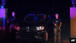 FILE - Armed Secret Service agents stand outside an entrance to former President Donald Trump's Mar-a-Lago estate, in Palm Beach, Fla., Aug. 8, 2022.