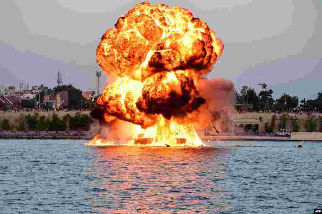 A dummy target is exploded by use of mines by Indian Navy's divers, as a part of rehearsals for the upcoming defense equipment exhibition - Defence Expo 2022 - at the Sabarmati Riverfront in Ahmedabad.