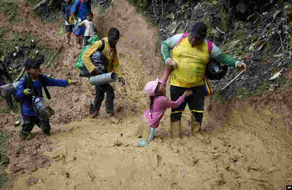 Ecuadorian migrants walk across the Darien Gap from Colombia into Panama hoping to reach the U.S., Oct. 15, 2022.