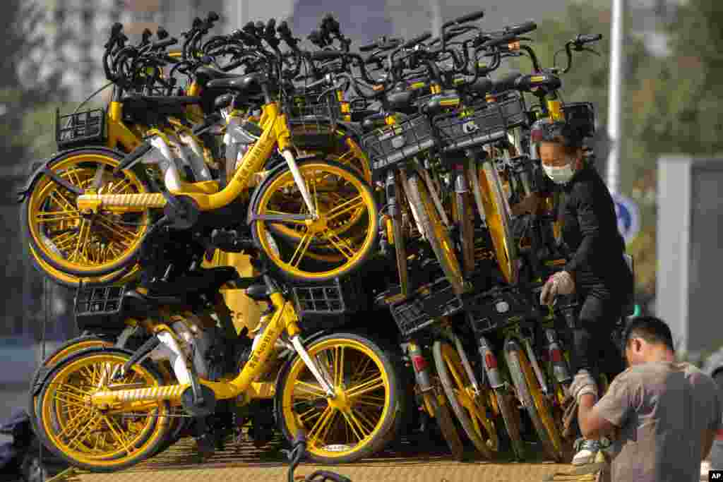 A trailer full of rental bicycles is seen parked along a street in Beijing, China.