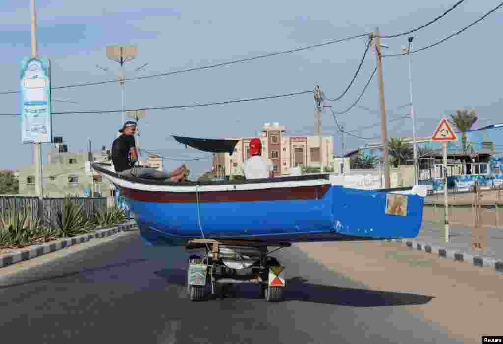 A fishing boat is transported on a horse cart in the northern Gaza Strip.