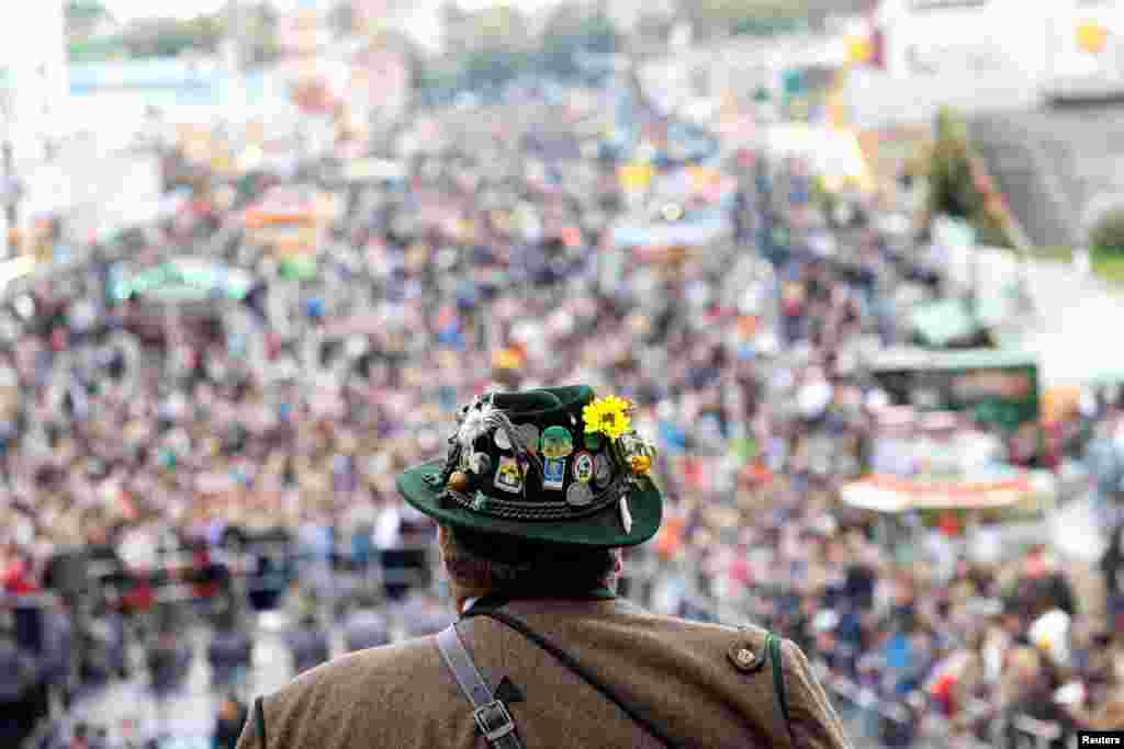 Traditionally dressed Bavarians arrive to shoot salute on the stairs of the Bavaria statue on the last day of the 187th Oktoberfest in Munich, Germany.