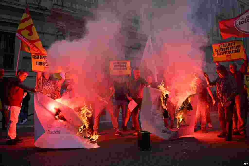 Protesters burn up their energy bills during a demonstration organized by Italian's Unione Sindacale di Base (USB) against the high cost of living and energy price rising in Rome.