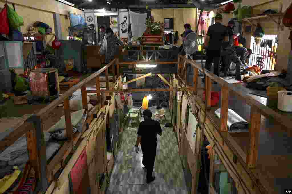 Police officers inspect the belongings of prison inmates during a search operation for contraband and illegal drugs at the Manila City Jail in Manila, Philippines.