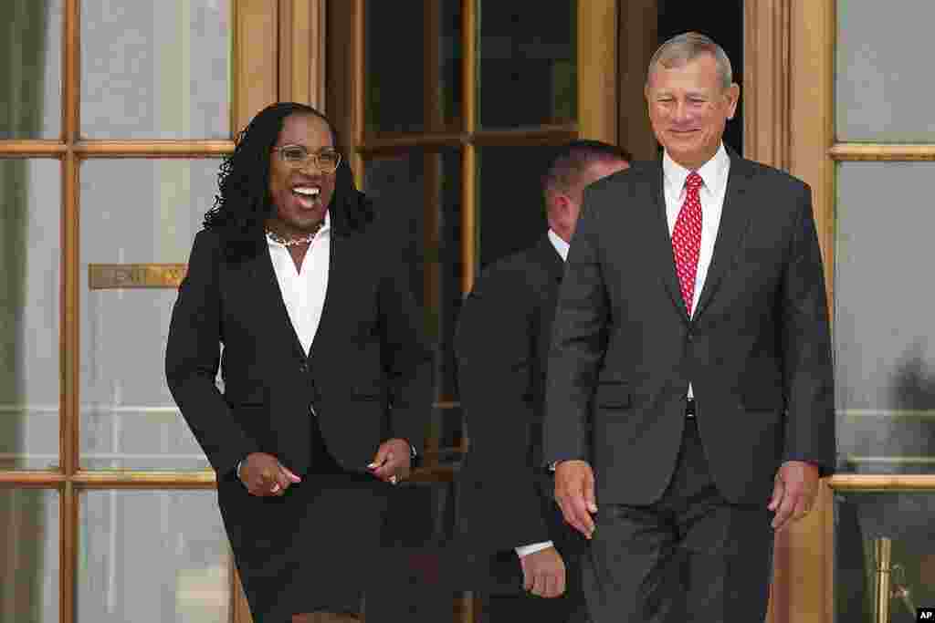 Supreme Court Associate Justice Ketanji Brown Jackson and Chief Justice of the United States John Roberts stand outside the Supreme Court following her formal investiture ceremony at the Supreme Court in Washington.