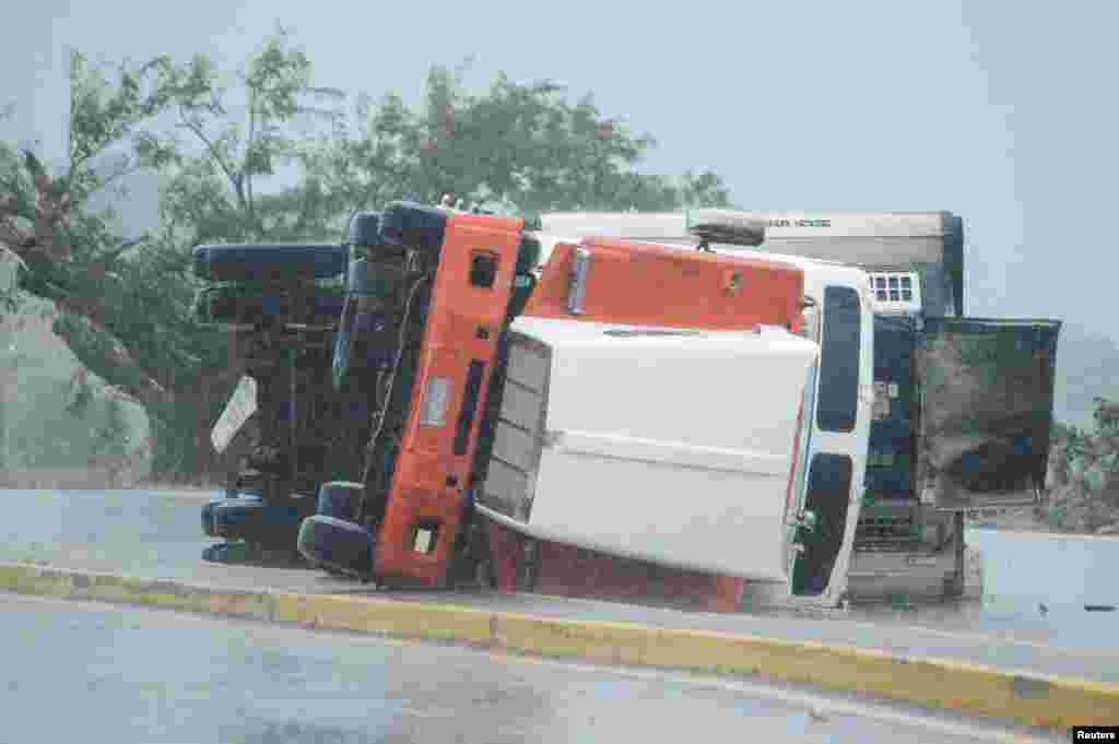 An overturned truck is seen on a highway following the passing of Hurricane Roslyn that hit the Mexico's Pacific coast with heavy winds and rain, in Tecuala in Nayarit state, Mexico.