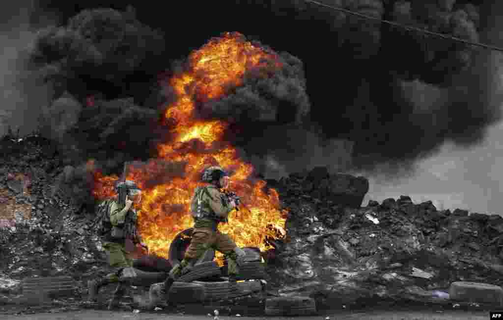 Israeli soldiers deploy amid clashes with Palestinian demonstrators following a protest against the expropriation of Palestinian land by Israel in the village of Kfar Qaddum in the occupied West Bank, near the Jewish settlement of Kedumim.