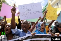FILE - University students join a demonstration condemning the gunmen attack at the Garissa University campus, in the Kenyan coastal port city of Mombasa, April 8, 2015.