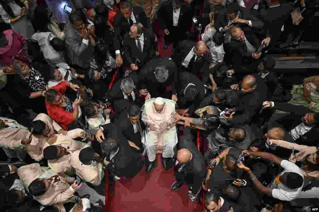 Pope Francis, center, leaves the Cathedral of Our Lady of Arabia in Awali, south of the Bahraini capital Manama.