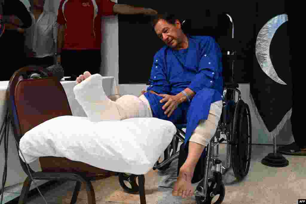 Pakistan's former Prime Minister Imran Khan speaks with media representatives at a hospital in Lahore, a day after an assassination attempt on him during his long march near Wazirabad. 