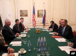 U.S. Secretary of State Rex Tillerson (L) speaks with his Russian counterpart Sergey Lavrov at the OSCE Foreign Ministers meeting in Vienna, Austria, Dec. 7, 2017
