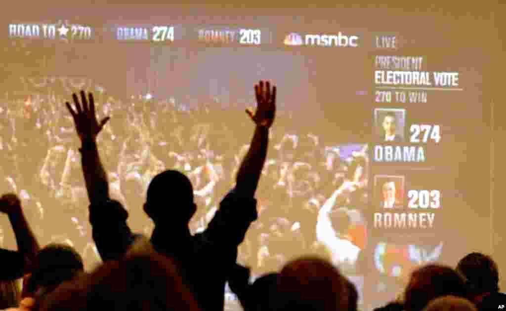 A Ukrainian soldier stands behind a fence while unidentified armed men block the headquarters of the Ukrainian Navy in Sevastopol.