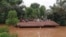 FILE - Villagers take refuge on a rooftop above flood waters from a collapsed dam in the Attapeu district of southeastern Laos, July 24, 2018.