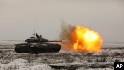 A Russian tank T-72B3 fires as troops take part in drills at the Kadamovskiy firing range in the Rostov region in southern Russia near its border with Ukraine, Jan. 12, 2022.