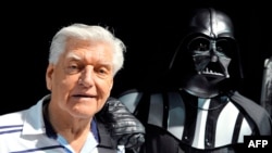 (FILES) This file photo taken on April 27, 2013 during a Star Wars convention in Cusset, central France, shows David Prowse, the British actor behind the menacing black mask of Star Wars villain Darth Vader, who died aged 85 his agent said on…