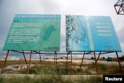 បដា​បង្ហាញ​គម្រោង​សាងសង់​អាកាសយានដ្ឋាន​នៅ​តំបន់​អភិវឌ្ឍ​របស់​ក្រុមហ៊ុន​ចិន Union Development Group ក្នុង​ឧទ្យាន​ជាតិ​បុទុមសាគរ ​ខេត្ត​កោះកុង​កាល​ពី​ថ្ងៃ​ទី​៦ ខែ​ឧសភា ឆ្នាំ​២០១៨។ (Reuters)