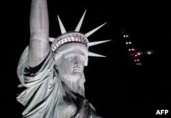 Solar Impulse 2 landed in New York early June 11, after flying by the Statue of Liberty at the end of the US portion of its bid to circle the globe using only solar power. (AFP PHOTO / Don EMMERT)