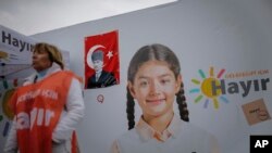 A woman stands in front of billboard that reads "NO for my future" in Istanbul, April 4, 2017. Turkey is heading to a contentious April 16 referendum on constitutional reforms to expand President Recep Tayyip Erdogan's powers.