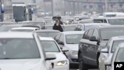 Motorists wait to cross the Croatian border from Slovenia, at Bregana border crossing, western Croatia, Saturday, Dec. 19, 2020. Balkan citizens going home from Western Europe for holidays have created huge traffic jams at border crossings despite coronav