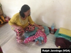A mother and her 3-month-old baby live on the floor at a Philippine evacuation center for refugees from war in nearby Marawi city, Nov. 15, 2017.