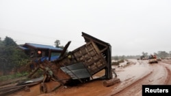 A military helicopter flies during the flood after the Xe Pian-Xe Namnoy hydropower dam collapsed in Attapeu province, Laos, July 26, 2018.
