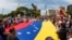 People carry Venezuela's national flag to protest the election results that awarded Venezuela's President Nicolas Maduro with a third term, in Maracaibo, Venezuela, July 30, 2024.