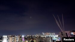 Rockets are fired towards Israel from the northern Gaza Strip, as seen from Ashkelon, southern Israel