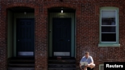 Jack Coopersmith sits outside his apartment and takes part in remote meeting while working from home amid the coronavirus disease (COVID-19) outbreak in Cambridge, Massachusetts,May 22, 2020.