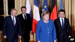 French President Emmanuel Macron, second left, Russian President Vladimir Putin, left, German Chancellor Angela Merkel and Ukrainian President Volodymyr Zelenskiy gather for talks at the Elysee Palace, in Paris, France, Dec. 9, 2019.