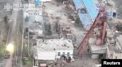 A tank fires a round, amid Russia's attack on Ukraine, in Soledar, Donetsk region, Ukraine, in this screen grab released on Jan. 8, 2023 and obtained from a social media video by Reuters on Jan. 10, 2023. State Border Guard Service Of Ukraine/via REUTERS