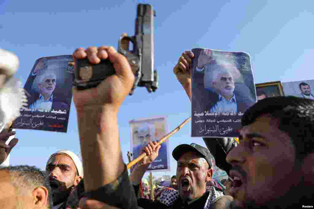 Protesters, mainly Houthi supporters, hold posters showing the late Hamas leader Yahya Sinwar as they rally to show support to Lebanon's Hezbollah and Palestinians in the Gaza Strip, in Sanaa, Yemen.