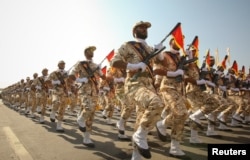 FILE - Members of the Iranian Revolutionary Guard march during a parade to commemorate the anniversary of the Iran-Iraq war (1980-88), in Tehran.