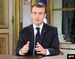 French President Emmanuel Macron speaks during a special address to the nation, his first public comments after four weeks of nationwide 'yellow vest' protests, Dec. 10, 2018, at the Elysee Palace, in Paris.
