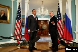 U.S. Secretary of State Rex Tillerson (R) waves to the media next to Russian Foreign Minister Sergey Lavrov before their meeting at the State Department in Washington, May 10, 2017. R